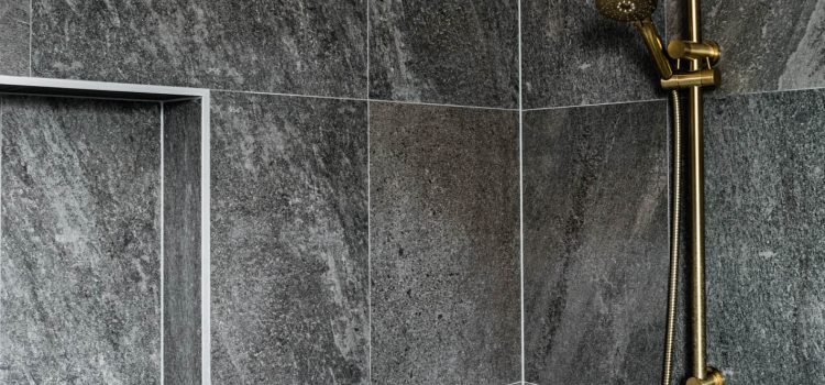 Dark Grey Porclin tiles with brushed brass tap wear